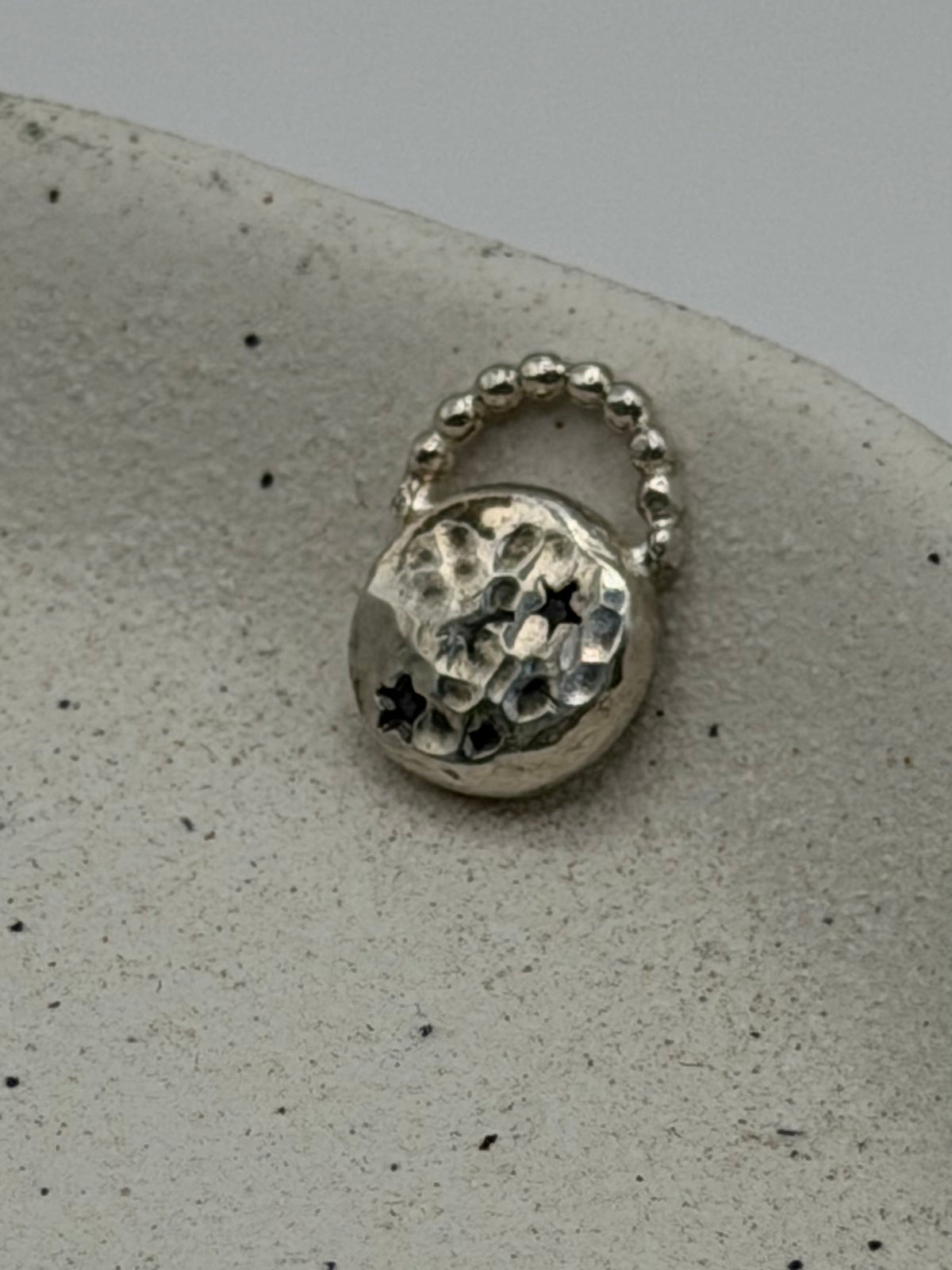 Handmade fine silver Love Lock charm featuring an organic, textured disc with softly rippled detail and a row of beaded silver detail.