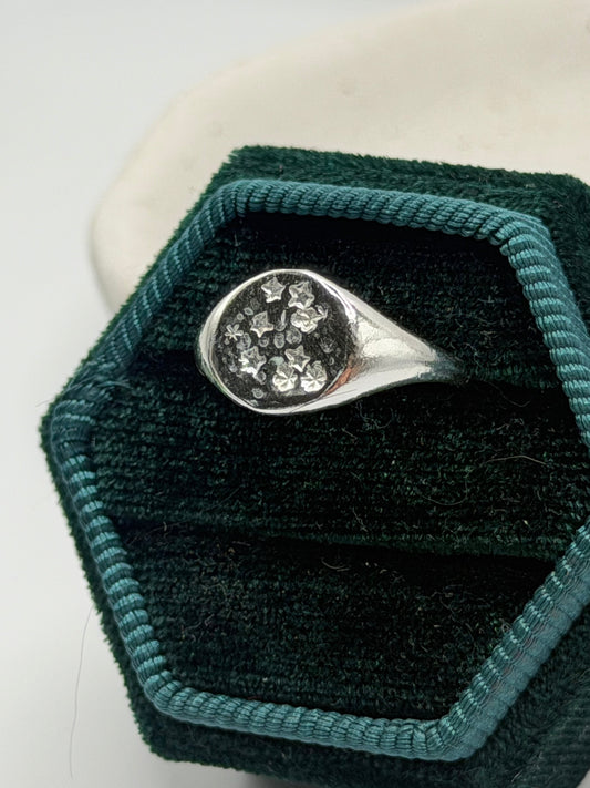 Handmade recycled sterling silver Galaxy Signet Ring featuring a circular dimple-textured face with tiny scattered star details, crafted in small batches by independent silversmith Wild One Jewellery in Lincolnshire, UK.