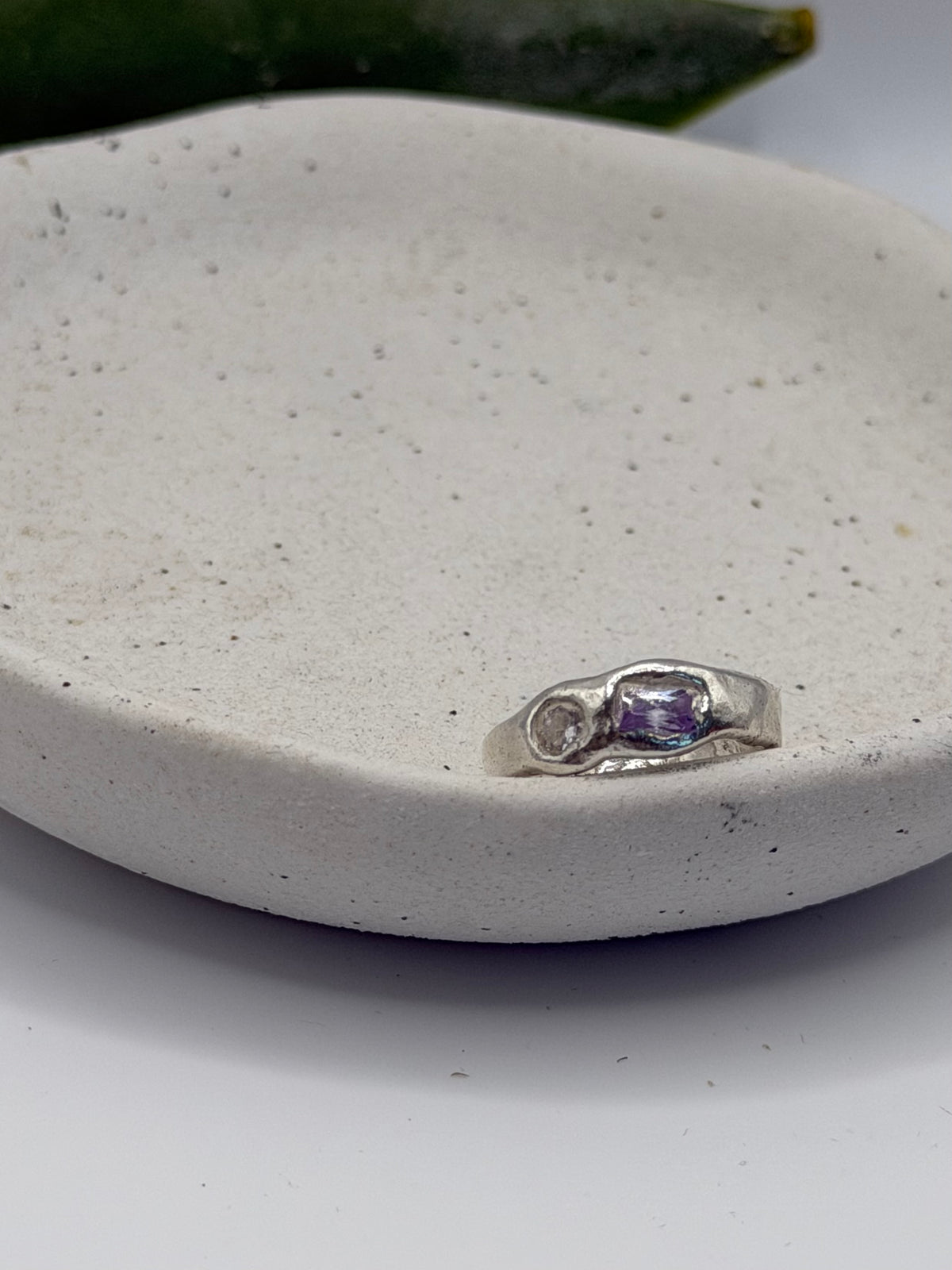 One-of-a-kind 999 fine silver ring from the Stone + Silver collection, featuring lavender-coloured and clear cubic zirconia gemstones set in a handcrafted design.