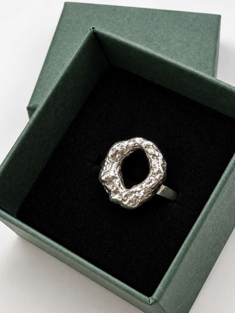 Handmade chunky Molten Circle ring crafted from recycled sterling silver, with an irregular lava-like texture created by melting the silver and quenching it in water to freeze its organic shape. Wild One Jewellery.