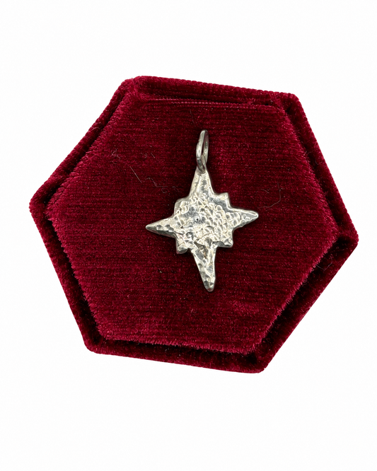 Handmade recycled sterling silver Midi Five-Point Star charm with softly rounded points and a dimple-textured finish, part of the Wild One Jewellery Charm Bar collection.