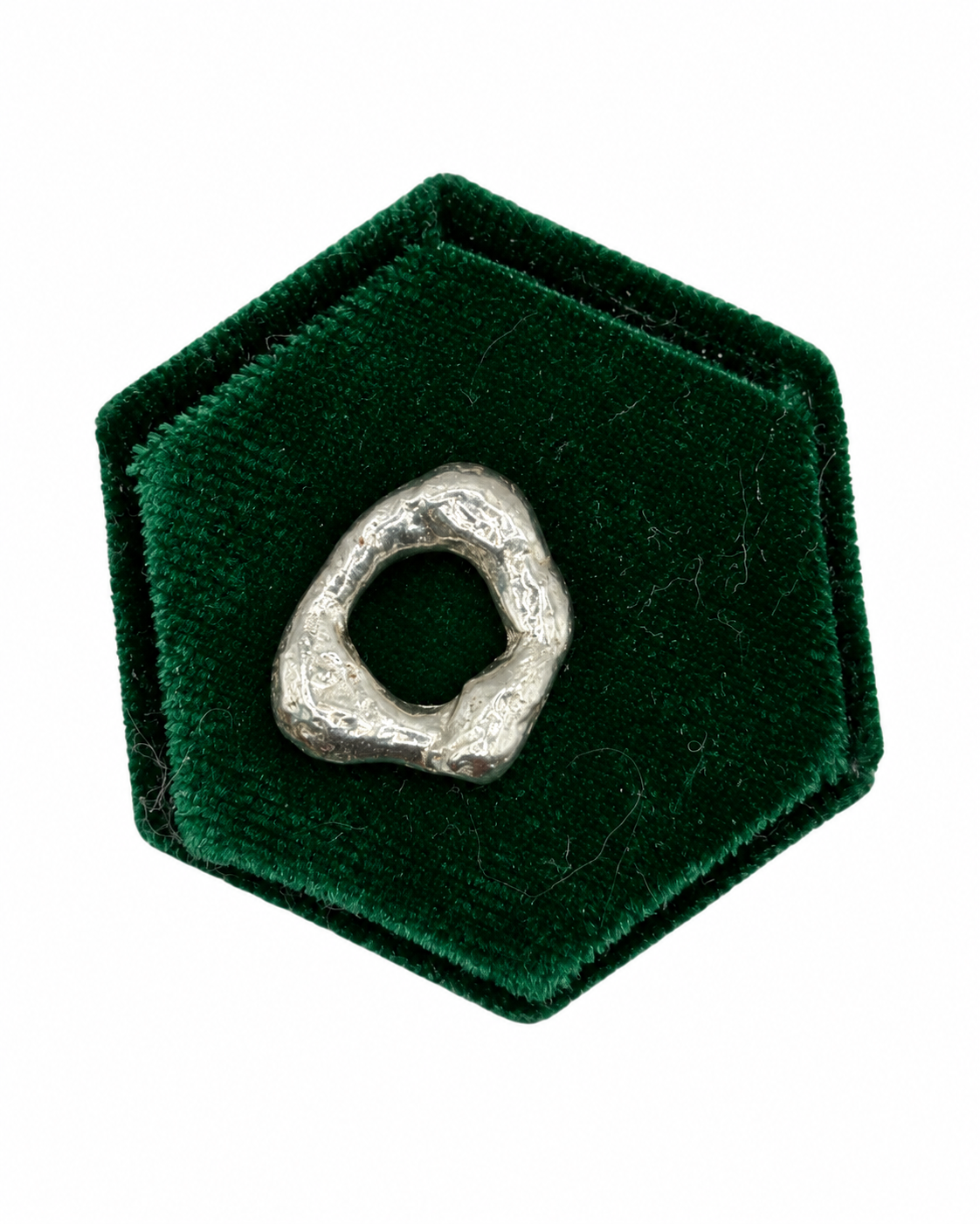 Molten No. 05 handmade recycled sterling silver charm by Wild One Jewellery, featuring a unique organic shape and raw lava-like texture created by melting and quenching silver.