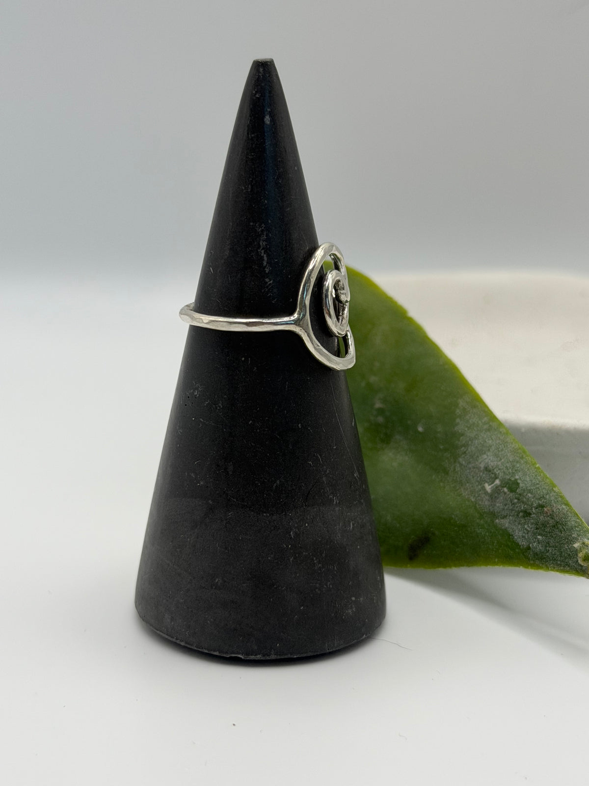 Handmade recycled sterling silver spiral ring with an organic swirl design and polished textured finish by Wild One Jewellery, Lincolnshire.