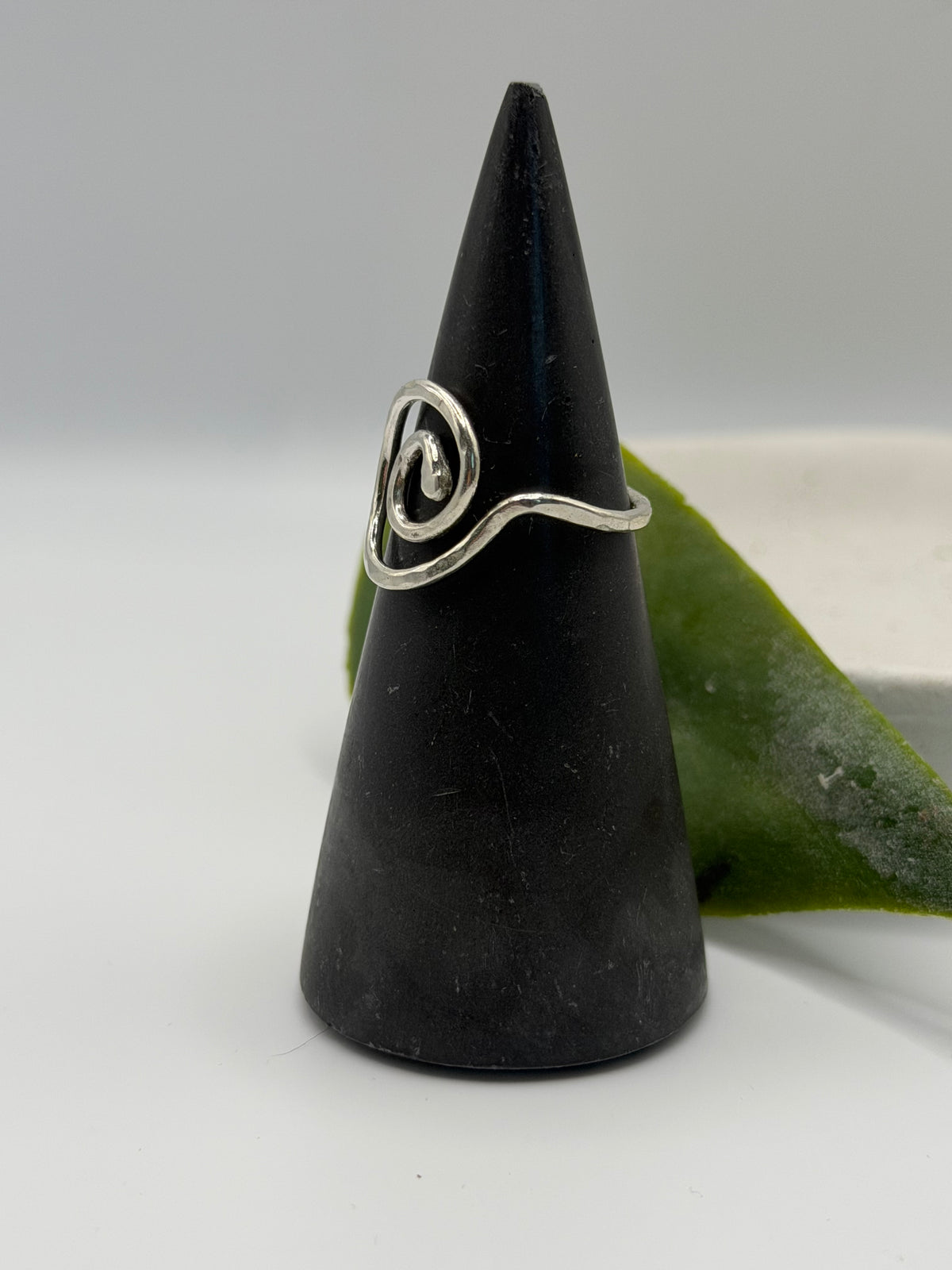 Handmade recycled sterling silver spiral ring with an organic swirl design and polished textured finish by Wild One Jewellery, Lincolnshire.