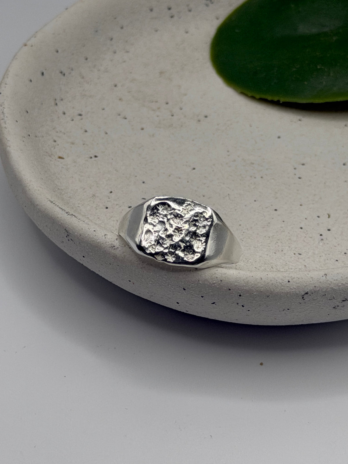 Handmade recycled sterling silver Galaxy Signet Ring featuring a circular dimple-textured face with tiny scattered star details, crafted in small batches by independent silversmith Wild One Jewellery in Lincolnshire, UK.