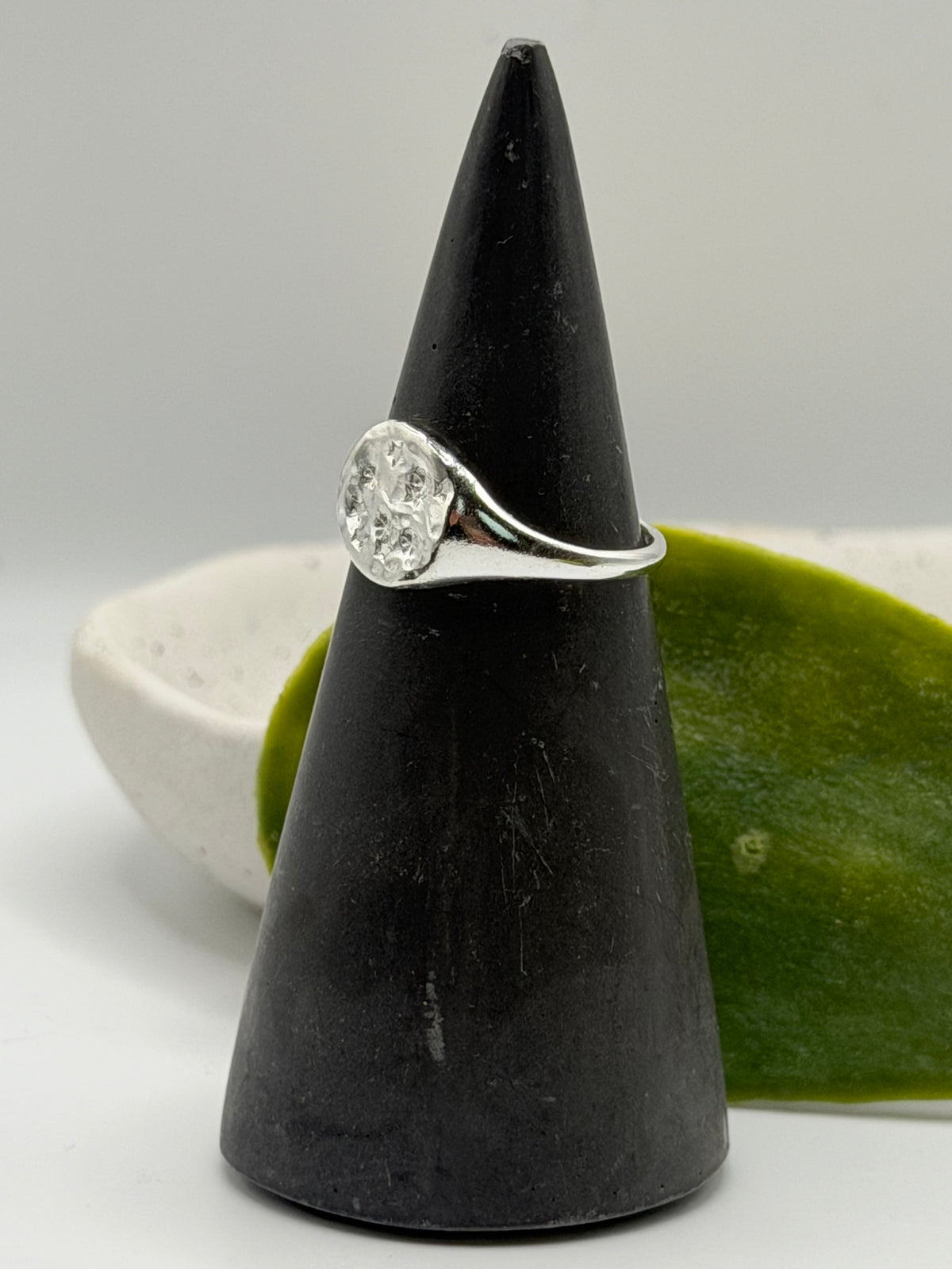 Handmade recycled sterling silver Galaxy Signet Ring featuring a circular dimple-textured face with tiny scattered star details, crafted in small batches by independent silversmith Wild One Jewellery in Lincolnshire, UK.