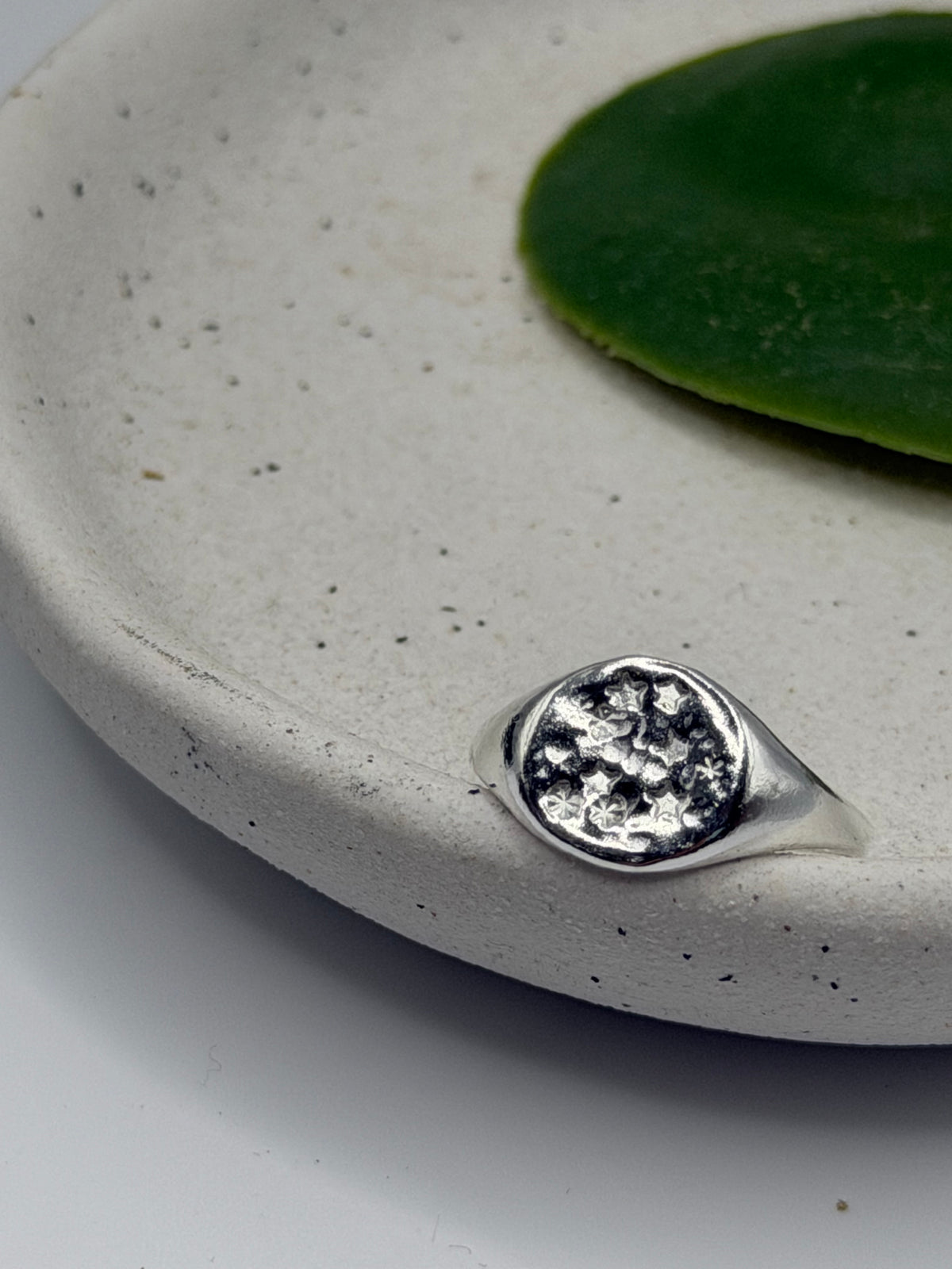 Handmade recycled sterling silver Galaxy Signet Ring featuring a circular dimple-textured face with tiny scattered star details, crafted in small batches by independent silversmith Wild One Jewellery in Lincolnshire, UK.